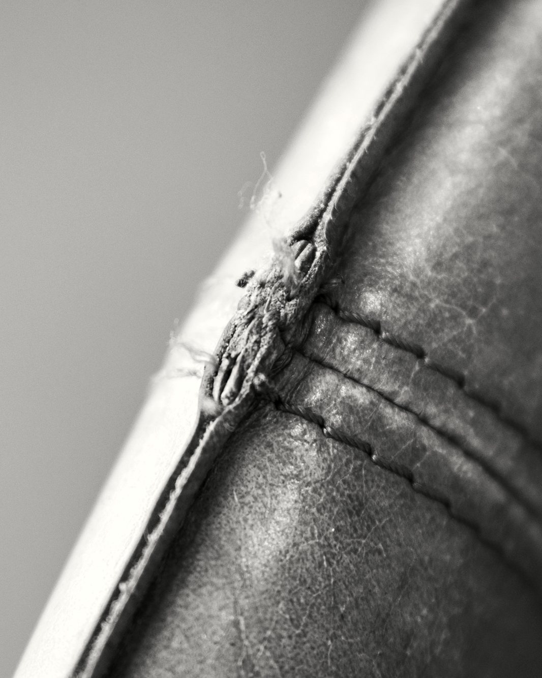 A close study of a folded leather edge and its stitching.